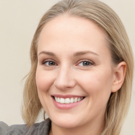 Joyful white young-adult female with medium  brown hair and blue eyes