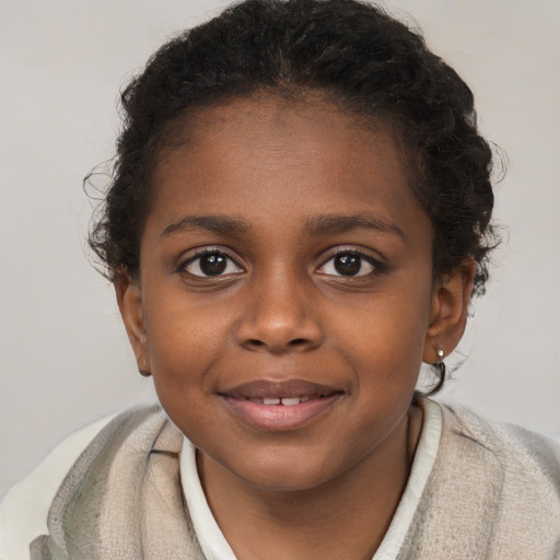 Joyful black child female with short  brown hair and brown eyes