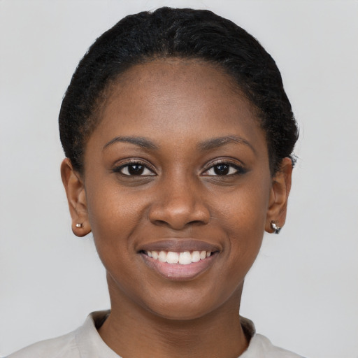 Joyful black young-adult female with short  black hair and brown eyes