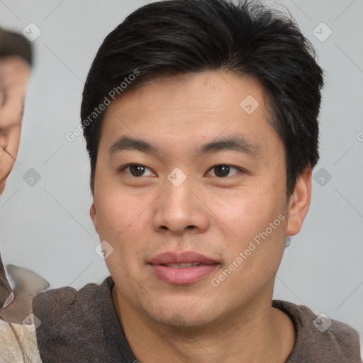 Joyful asian young-adult male with short  brown hair and brown eyes