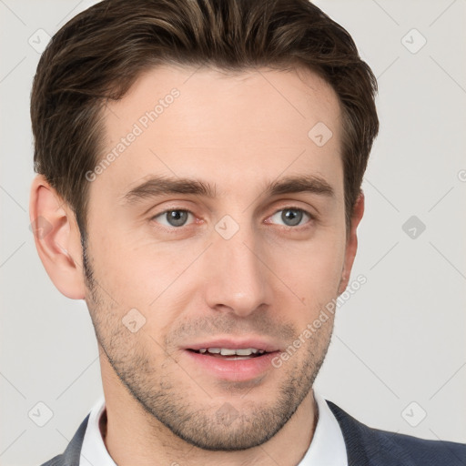 Joyful white young-adult male with short  brown hair and grey eyes