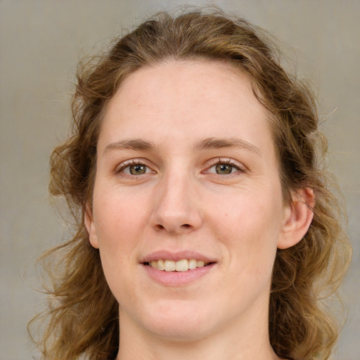 Joyful white young-adult female with medium  brown hair and green eyes