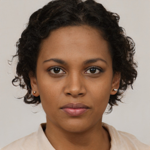 Neutral black young-adult female with medium  brown hair and brown eyes