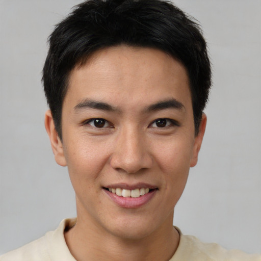 Joyful asian young-adult male with short  brown hair and brown eyes