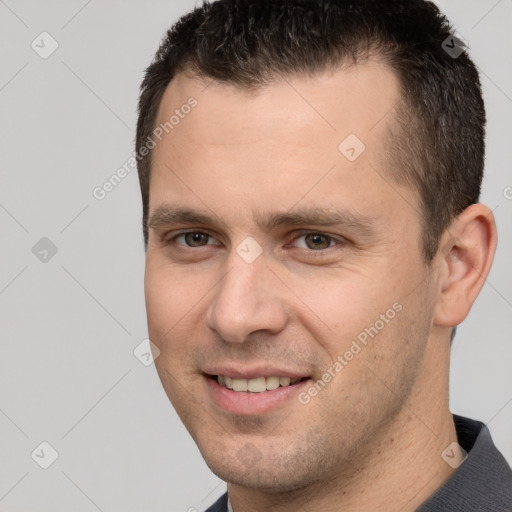 Joyful white young-adult male with short  brown hair and brown eyes