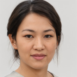 Joyful asian young-adult female with medium  brown hair and brown eyes