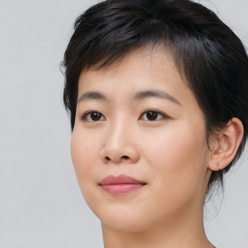 Joyful asian young-adult female with medium  brown hair and brown eyes