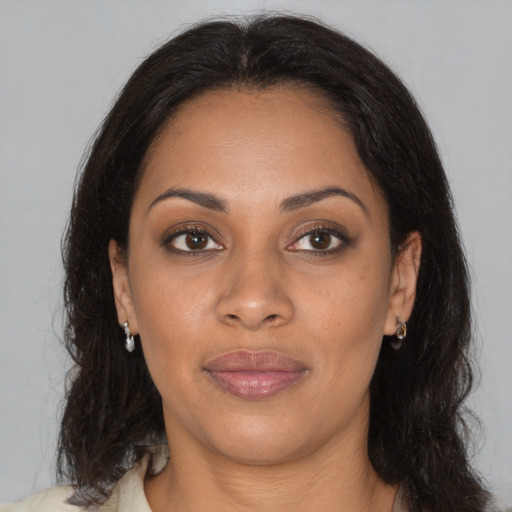 Joyful black young-adult female with medium  brown hair and brown eyes