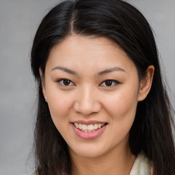 Joyful asian young-adult female with long  brown hair and brown eyes