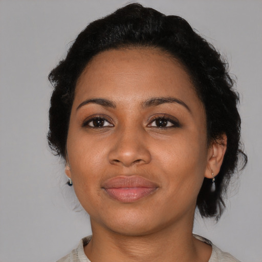 Joyful black young-adult female with medium  black hair and brown eyes