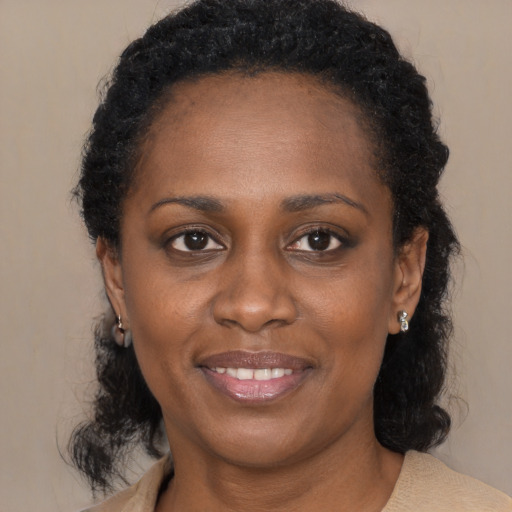 Joyful black young-adult female with medium  black hair and brown eyes