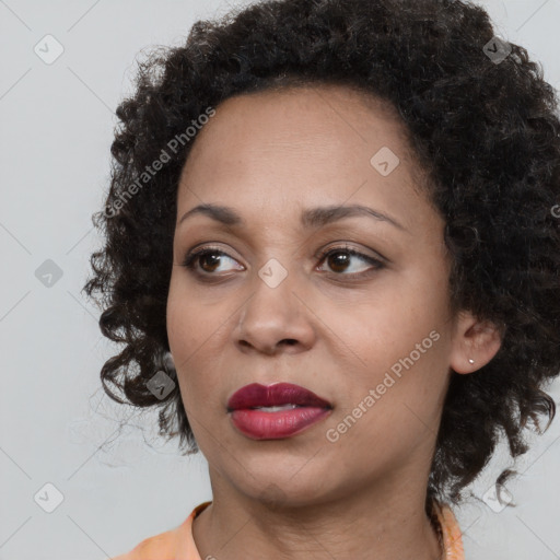 Joyful black young-adult female with medium  brown hair and brown eyes