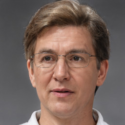 Joyful white middle-aged male with short  brown hair and brown eyes