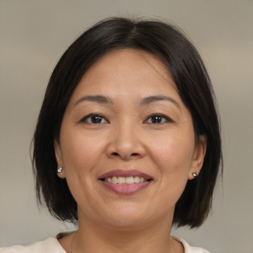 Joyful white adult female with medium  brown hair and brown eyes