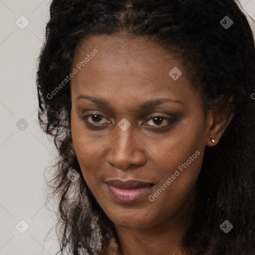 Joyful black young-adult female with long  brown hair and brown eyes