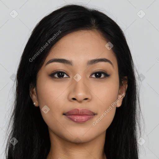 Joyful latino young-adult female with long  brown hair and brown eyes