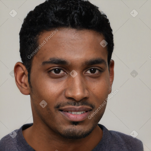 Joyful black young-adult male with short  brown hair and brown eyes