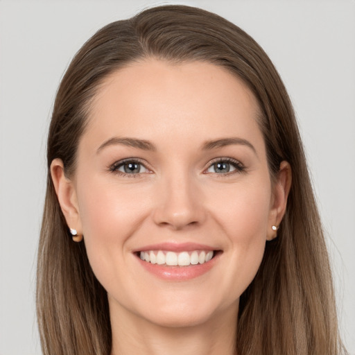 Joyful white young-adult female with long  brown hair and grey eyes