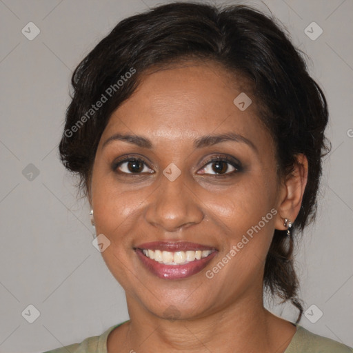 Joyful black adult female with medium  brown hair and brown eyes