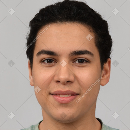 Joyful latino young-adult male with short  brown hair and brown eyes