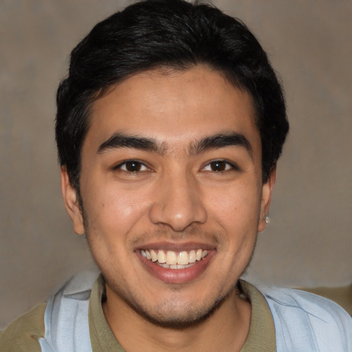 Joyful latino young-adult male with short  black hair and brown eyes