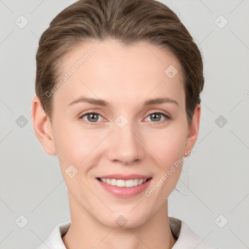 Joyful white young-adult female with short  brown hair and grey eyes