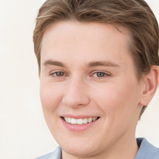 Joyful white young-adult female with short  brown hair and grey eyes