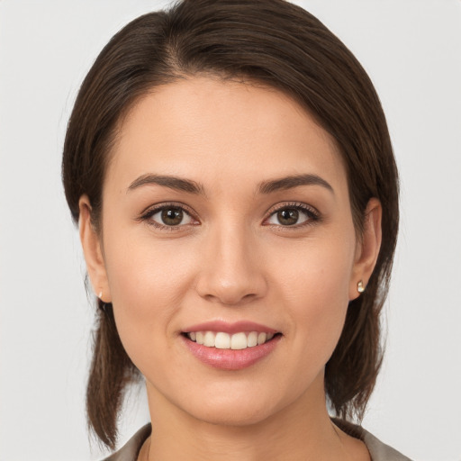 Joyful white young-adult female with medium  brown hair and brown eyes