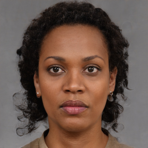 Neutral black young-adult female with medium  brown hair and brown eyes