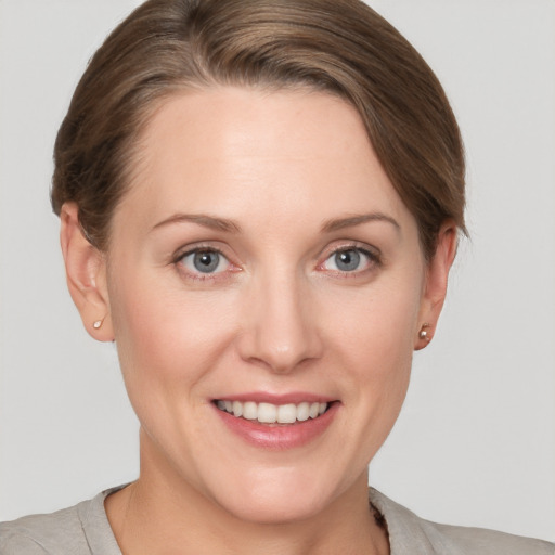 Joyful white young-adult female with short  brown hair and grey eyes