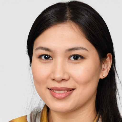 Joyful latino young-adult female with long  brown hair and brown eyes