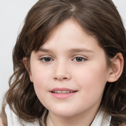 Joyful white child female with medium  brown hair and brown eyes