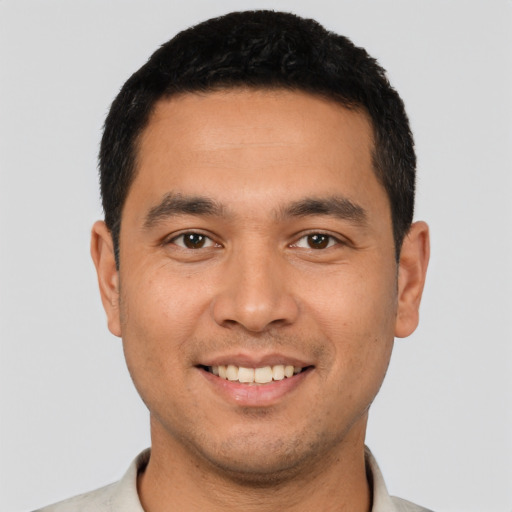 Joyful latino young-adult male with short  black hair and brown eyes