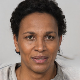 Joyful black adult female with short  brown hair and brown eyes