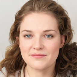 Joyful white young-adult female with medium  brown hair and green eyes