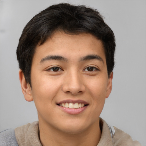 Joyful asian young-adult male with short  brown hair and brown eyes