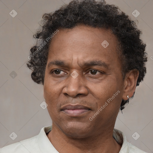 Joyful latino adult male with short  brown hair and brown eyes