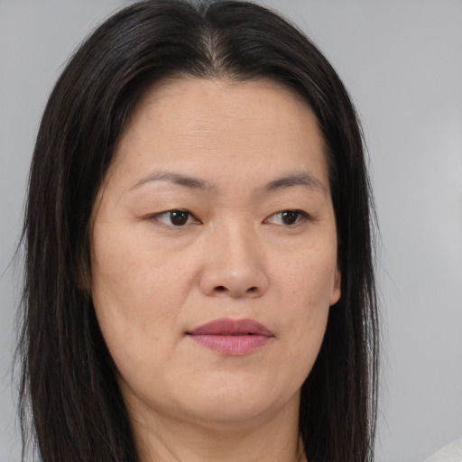 Joyful asian young-adult female with long  brown hair and brown eyes