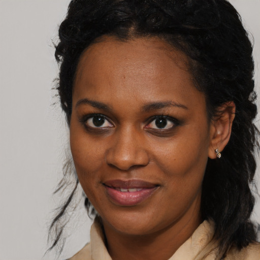 Joyful black young-adult female with medium  brown hair and brown eyes
