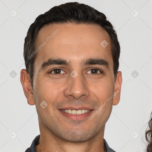 Joyful white young-adult male with short  black hair and brown eyes