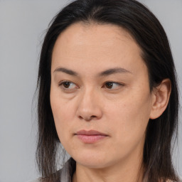 Joyful asian young-adult female with long  brown hair and brown eyes