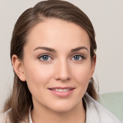 Joyful white young-adult female with medium  brown hair and grey eyes