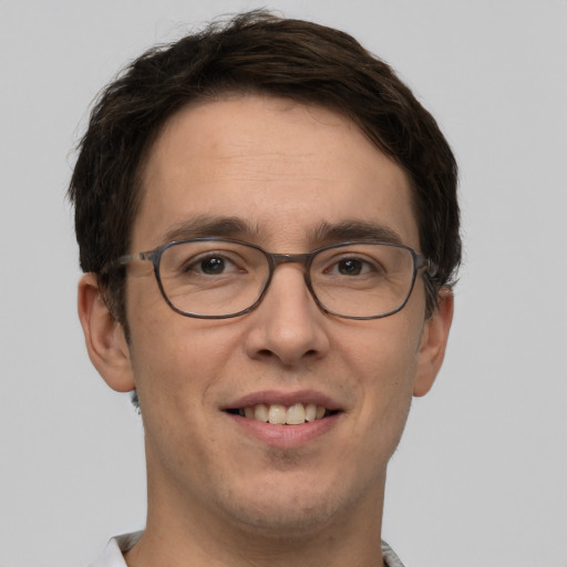 Joyful white young-adult male with short  brown hair and green eyes