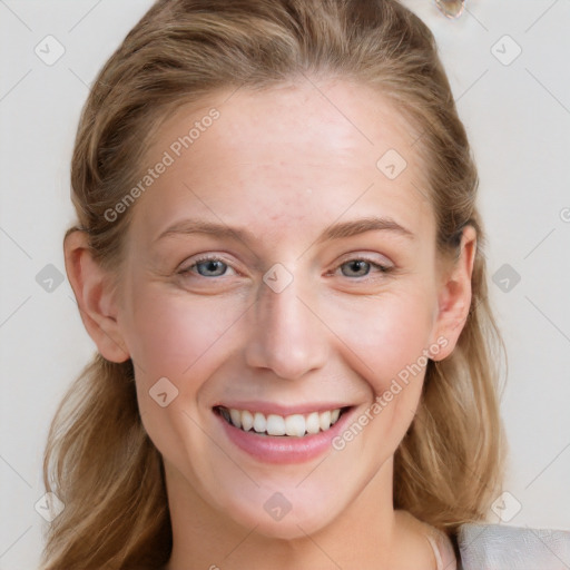 Joyful white young-adult female with long  brown hair and blue eyes