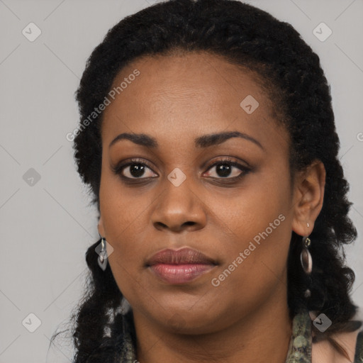 Joyful black young-adult female with long  black hair and brown eyes