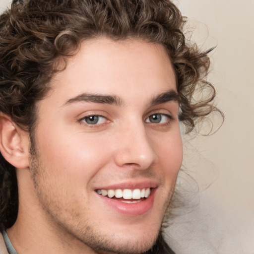 Joyful white young-adult male with medium  brown hair and brown eyes