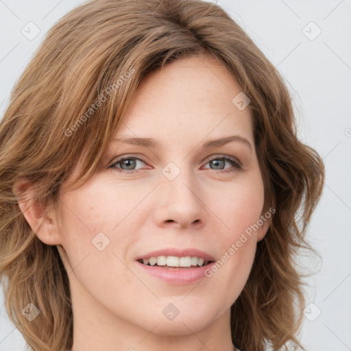 Joyful white young-adult female with long  brown hair and green eyes