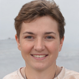 Joyful white young-adult female with short  brown hair and grey eyes