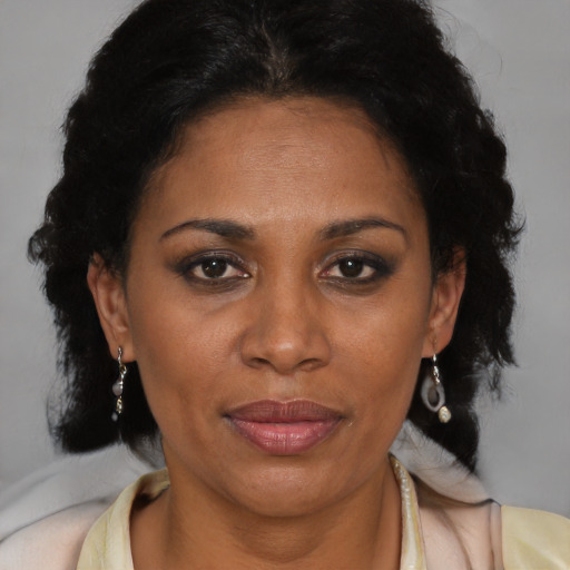 Joyful black adult female with short  brown hair and brown eyes