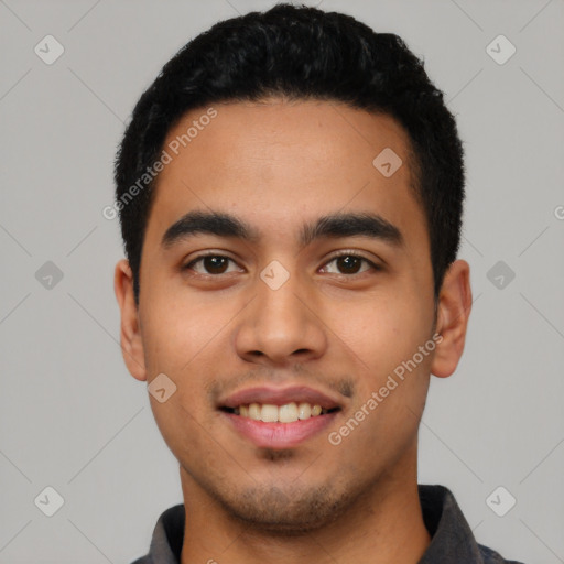 Joyful latino young-adult male with short  black hair and brown eyes